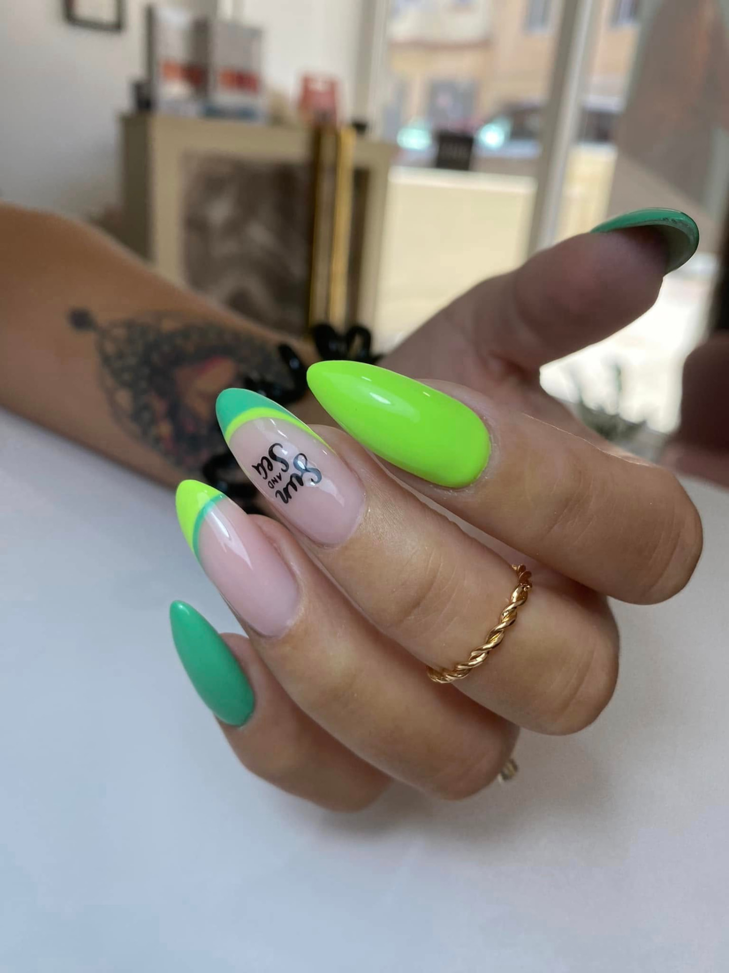 Neon green almond nails with hand-painted summer lettering nail art